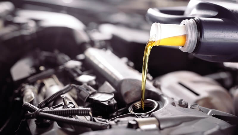 Clean engine oil being poured into an engine