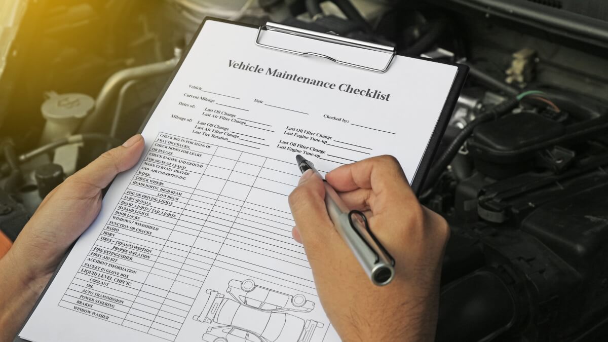 Auto mechanics using a vehicle maintenance checklist