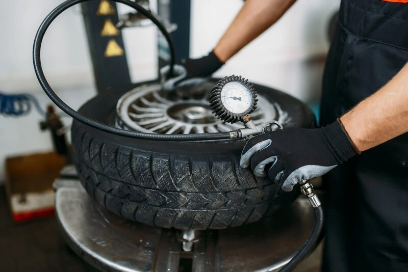 technician inflating winter tires with nitrogen