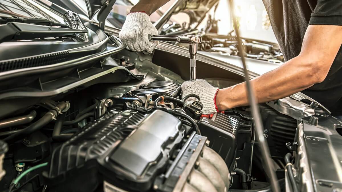 Mechanic performing engine maintenance