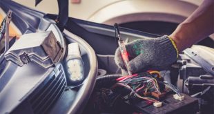 Auto mechanic testing an electrical circuit using a test light