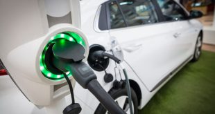 White electric vehicle being charged