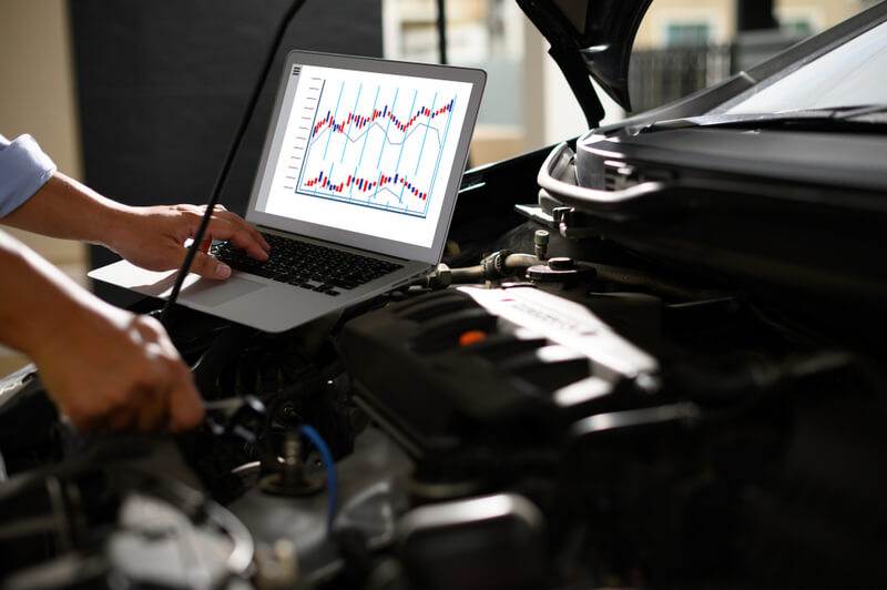 Auto mechanic doing an engine tune up