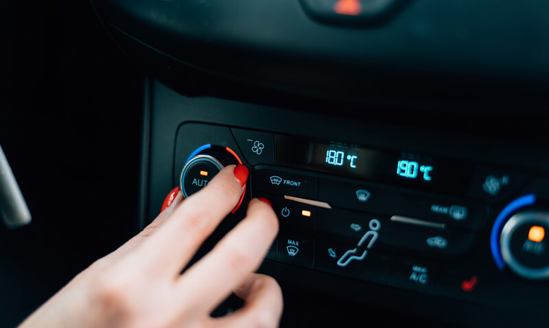 Women adjusting car temperature