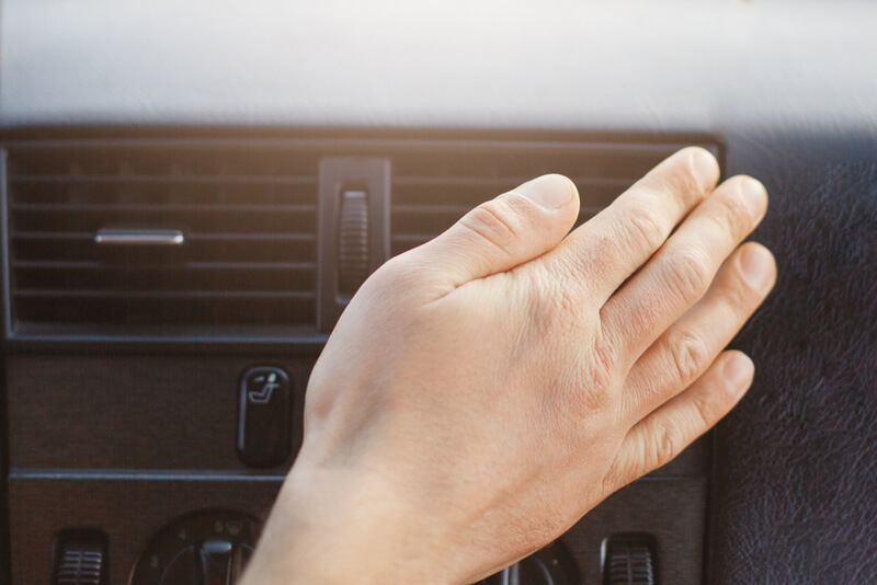 Man adjusting car air vent