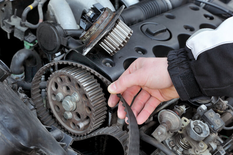 Auto mechanic replacing a bad water pump