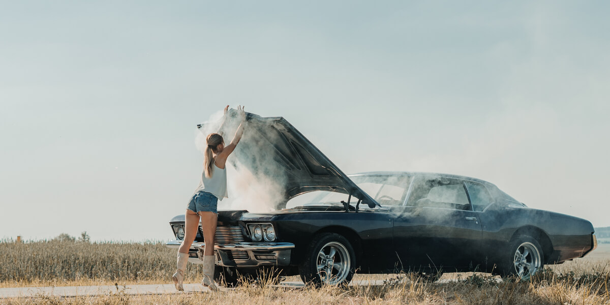 Woman in front of an overheating car