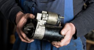 Auto mechanic replacing a starter