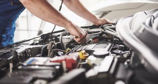 Auto mechanic performing car maintenance