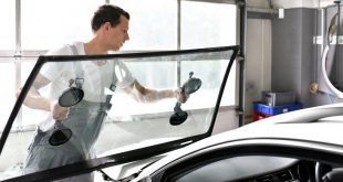 Technician replacing a windshield