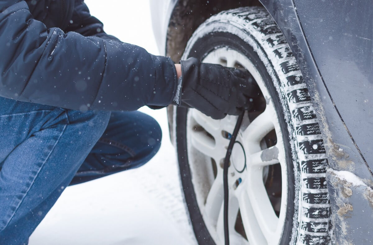 Man inflating winter tires