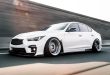 White Infiniti with negative camber suspension