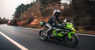 female driver driving hi-tech motorcycle