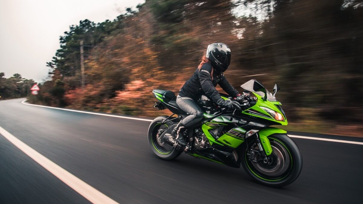 female driver driving hi-tech motorcycle