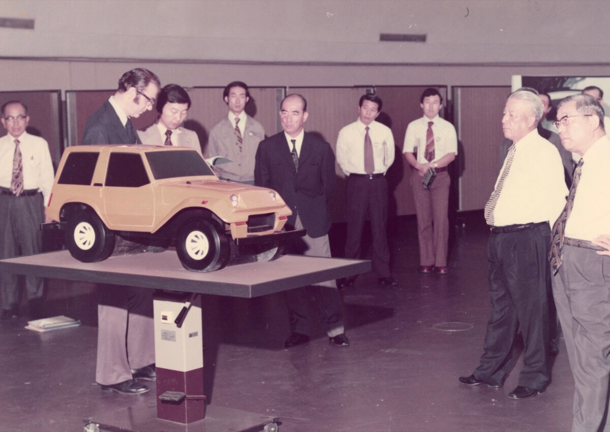 The President of TMC, Eiji Toyoda (standing far right) reviewing the FJ40 proposal with the CALTY staff.