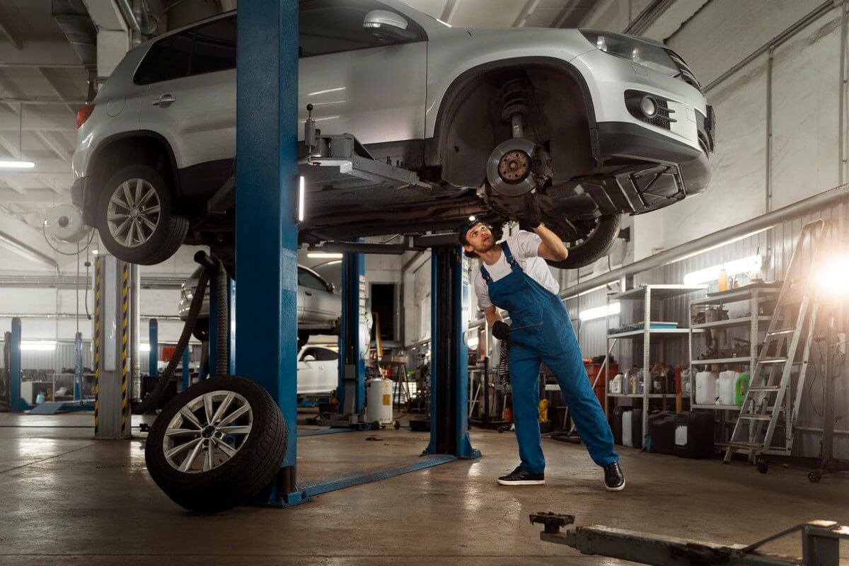 Mechanic working on a car on a lift