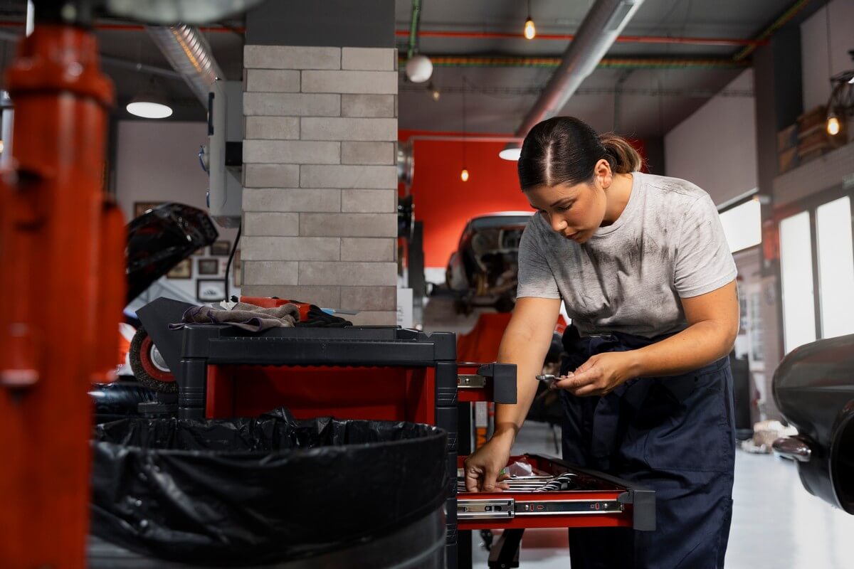 Female mechanic organizing and cleaning her tool chest